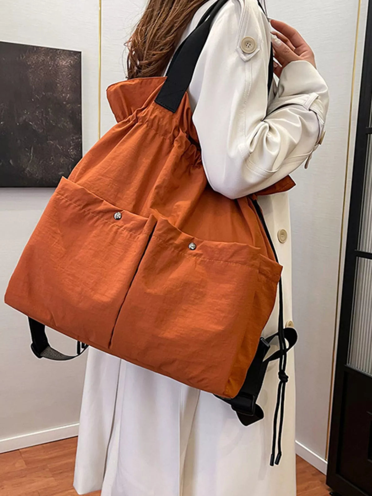 Drawstring nylon backpack worn on the back