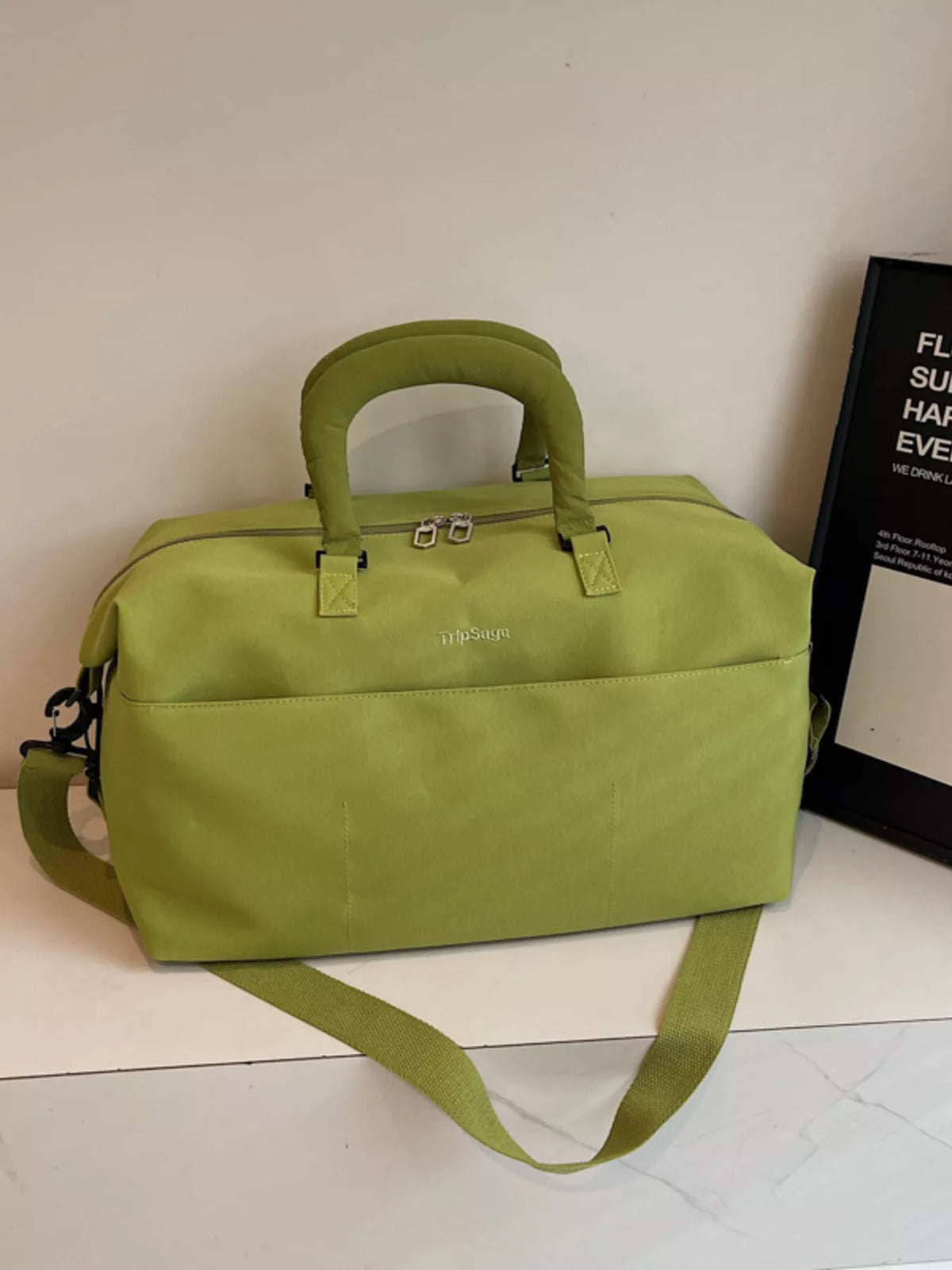 Green duffel bag side view