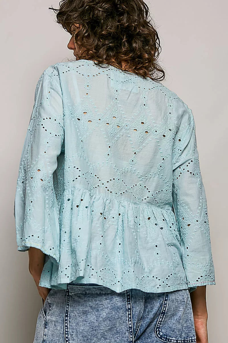 Button front and scooped neckline detail on the aqua shirt