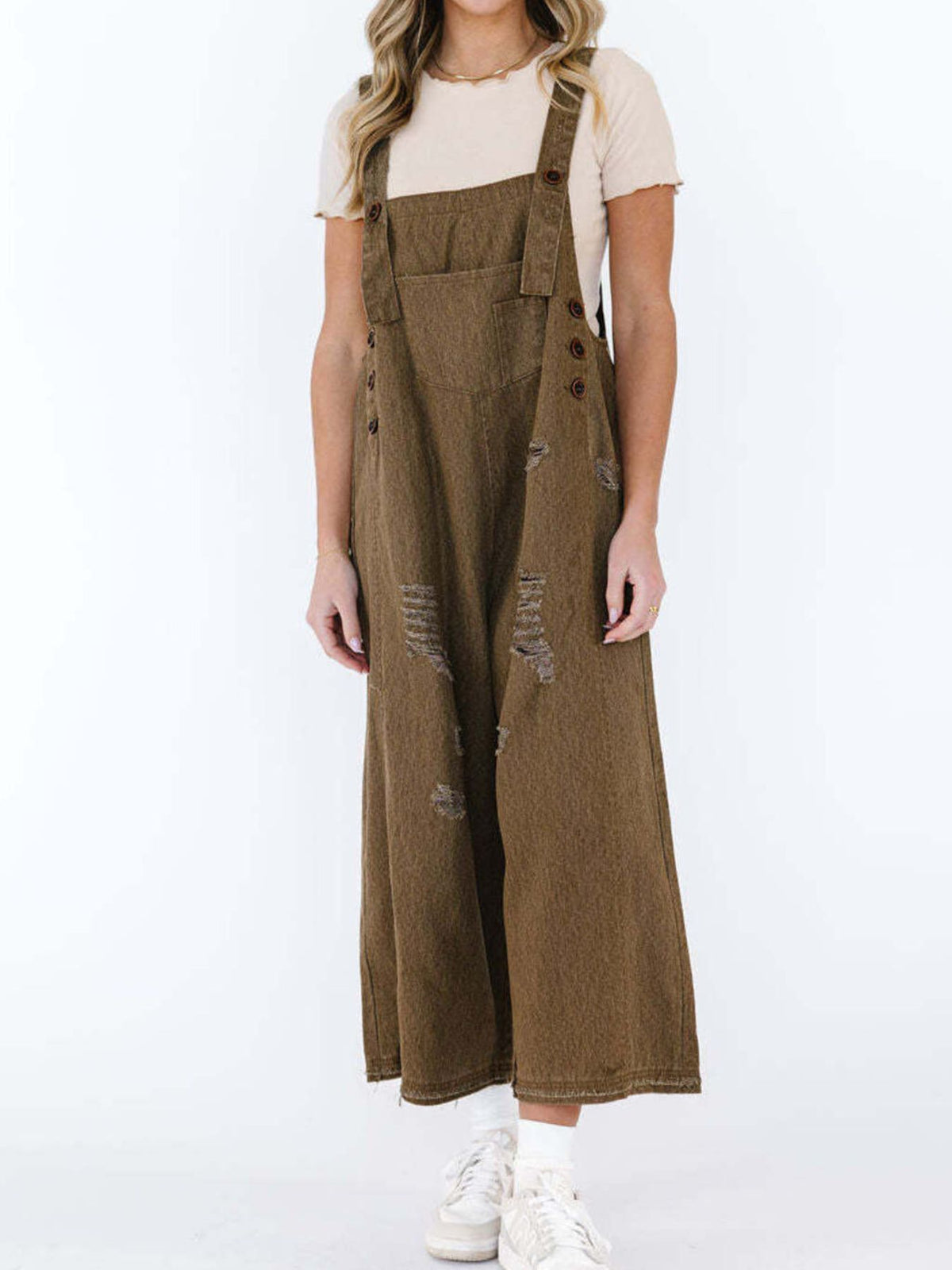 Distressed denim overalls close up