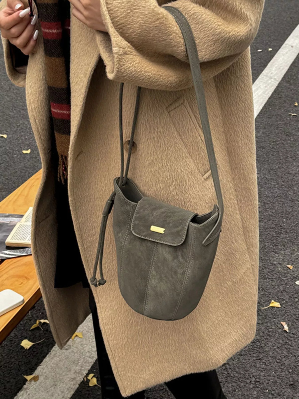 Suede texture detail on green bucket bag