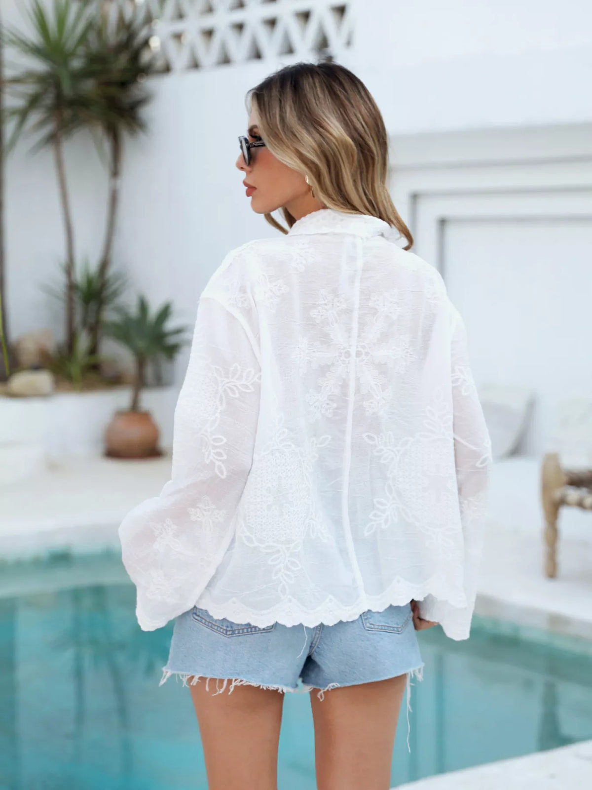 White embroidered button up shirt fabric detail