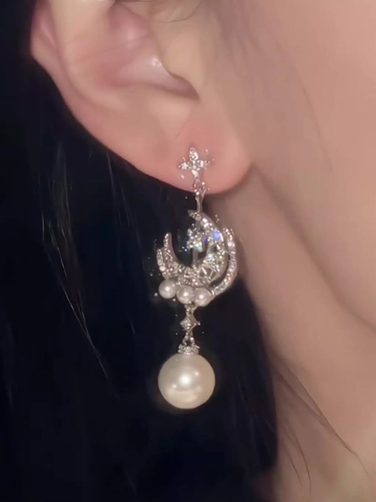 Moon and star pearl dangle earrings in silver tone, back view