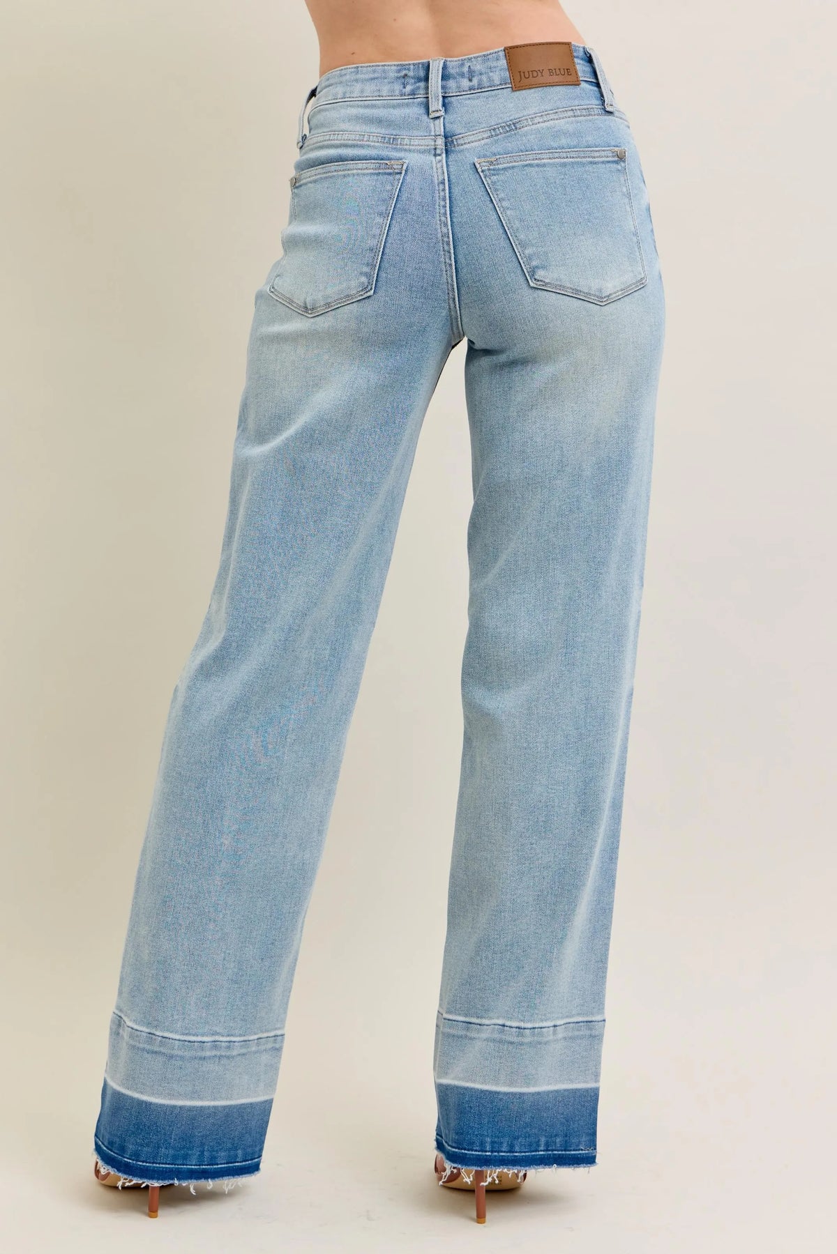 Model wearing light wash wide leg jeans