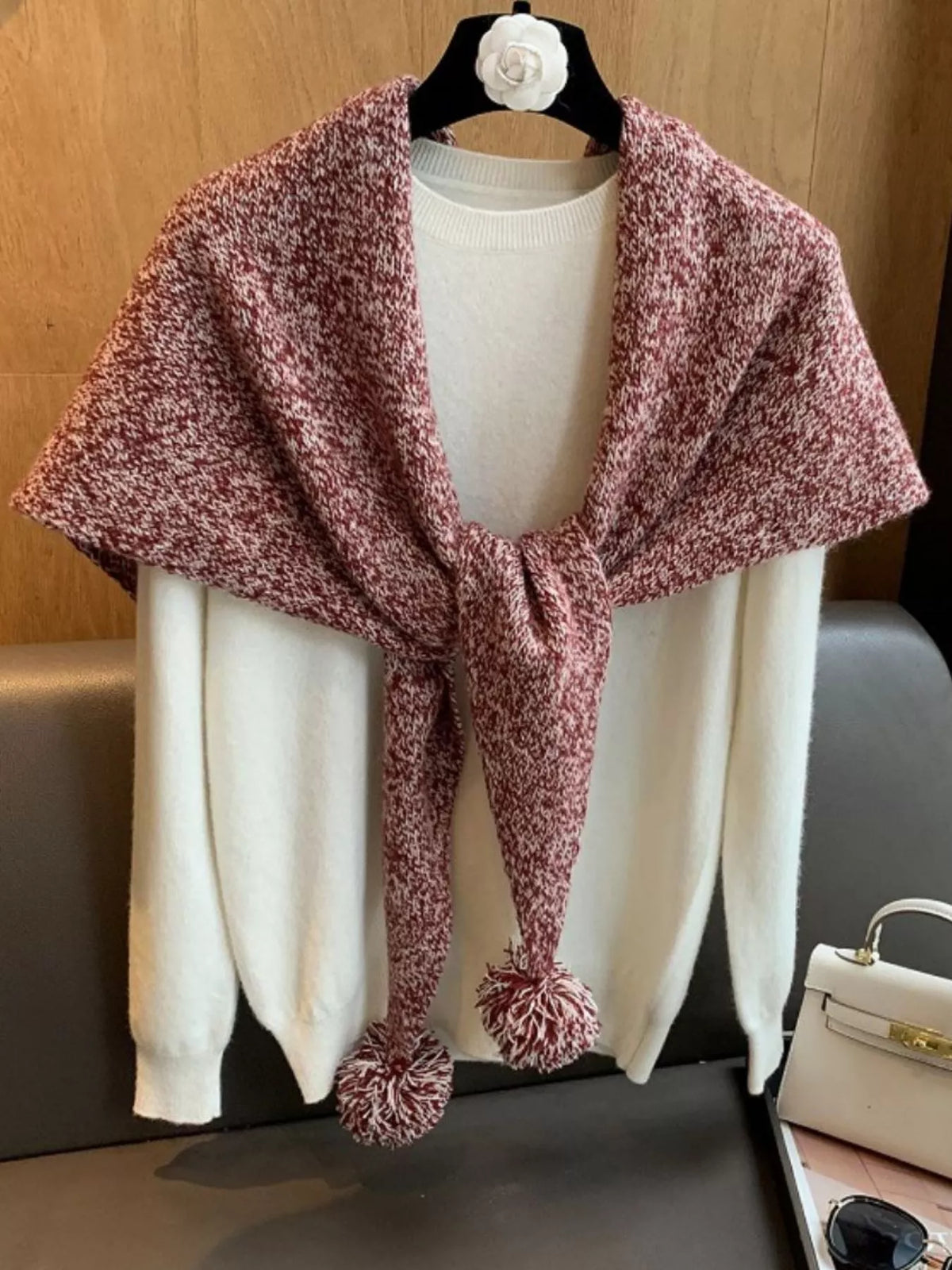 100 percent wool pom pom knitted scarf shown around the neck