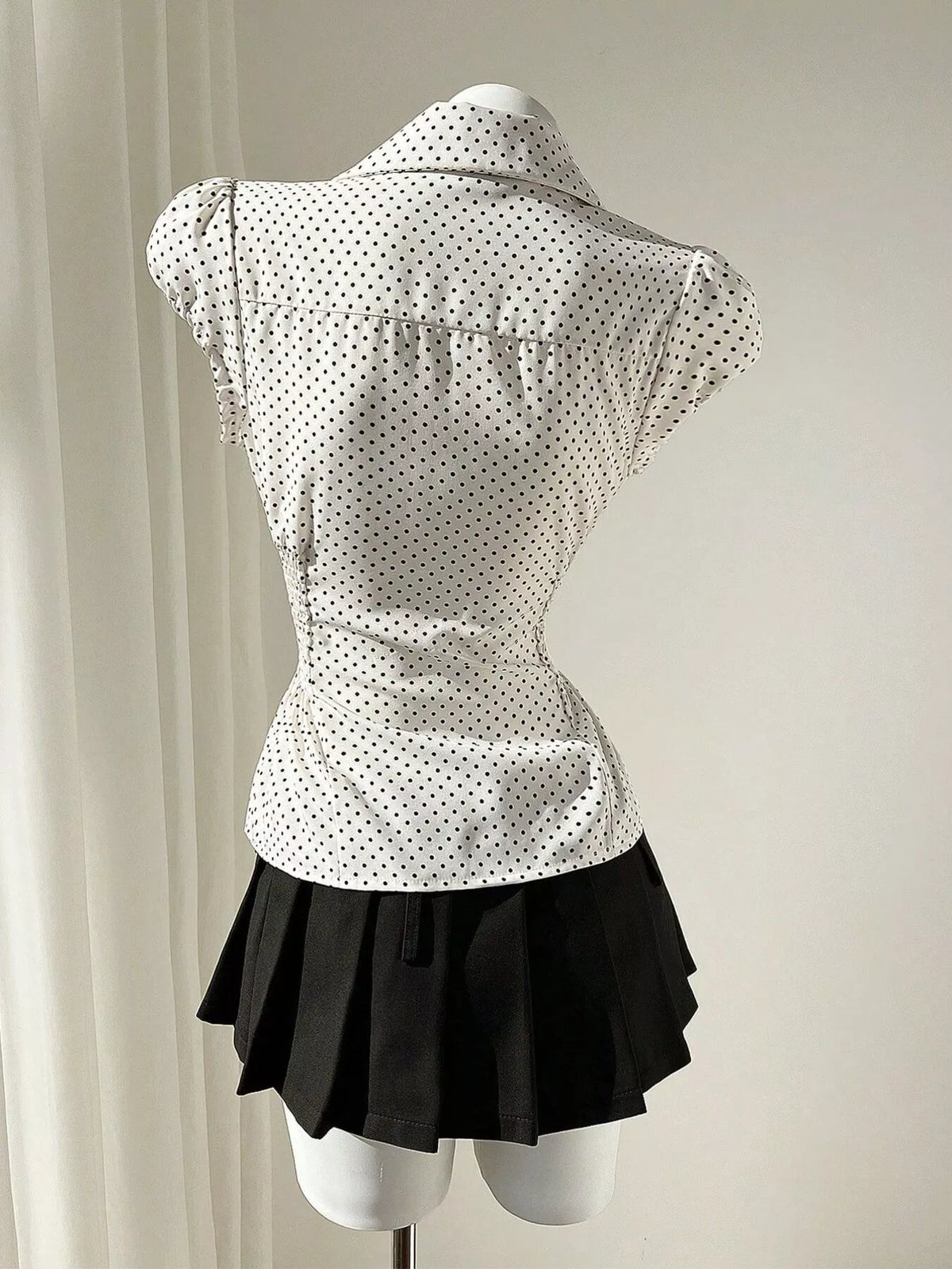 Close up of the polka dot print on the blouse