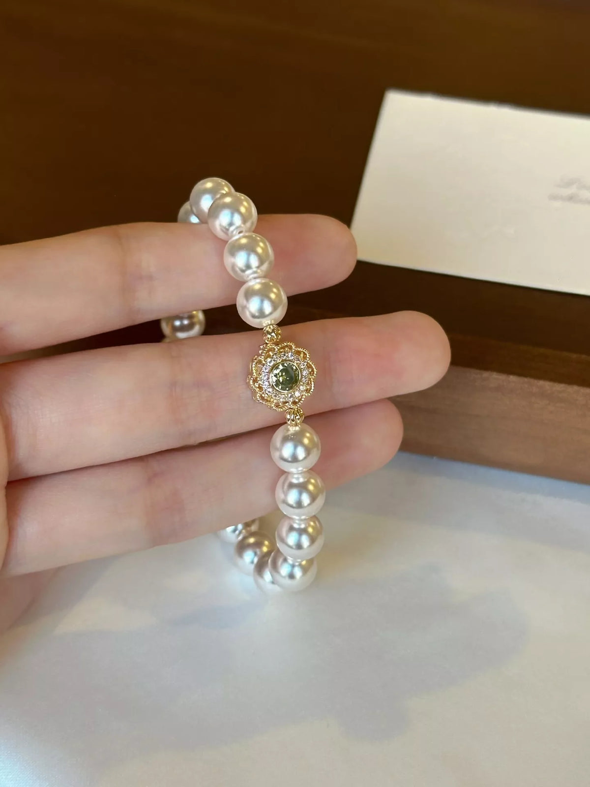 gold pearl flower bracelet styled on model