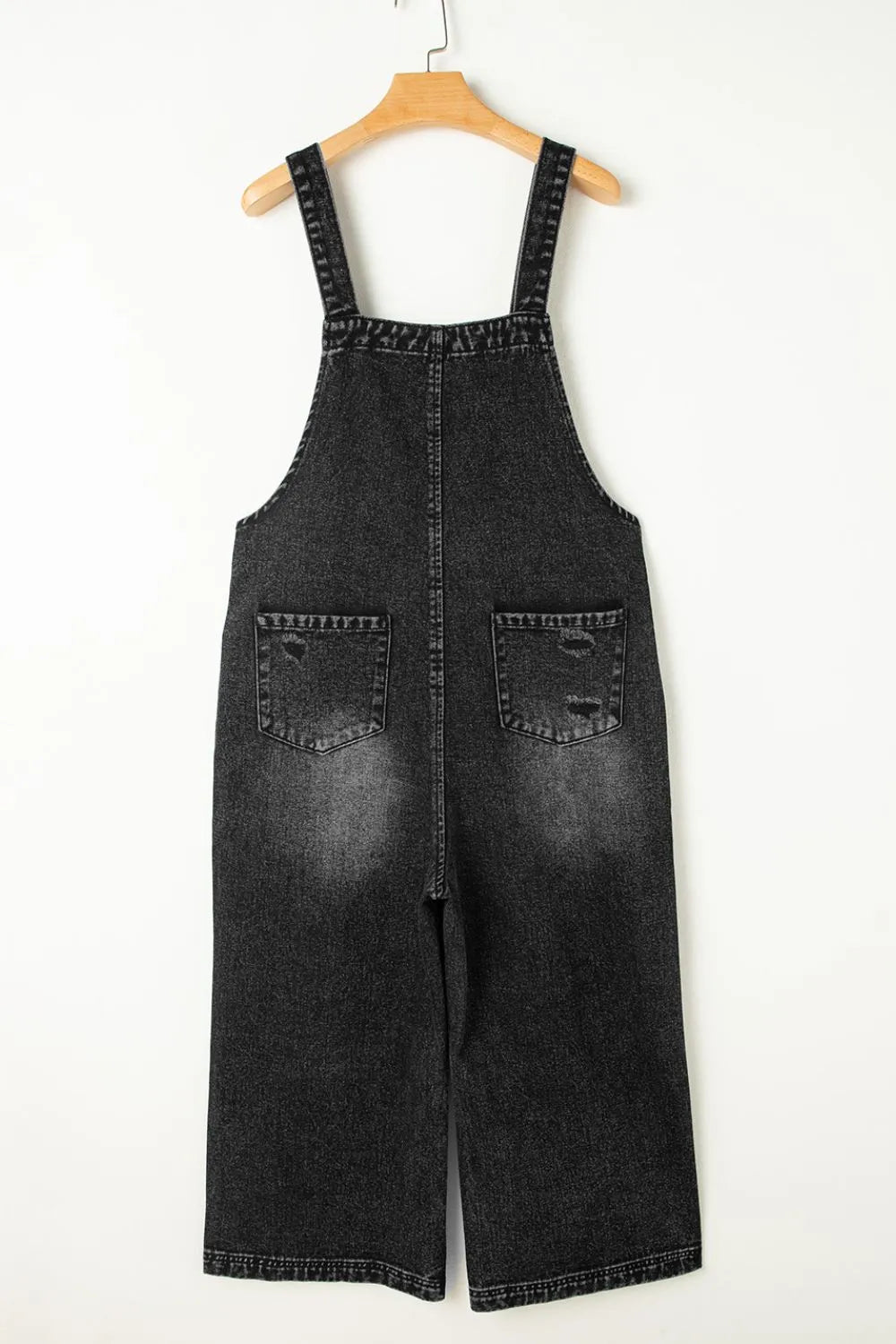 Distressed denim overalls back view