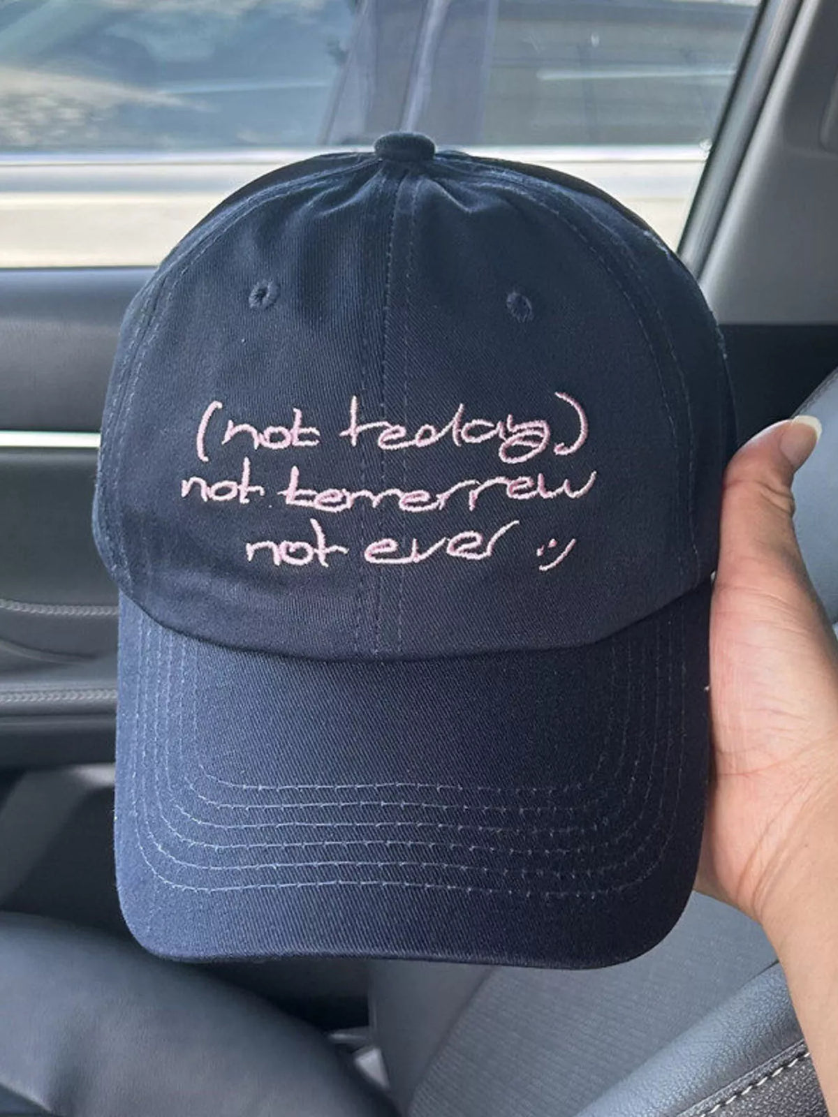 Close up of embroidery detail on cotton baseball cap
