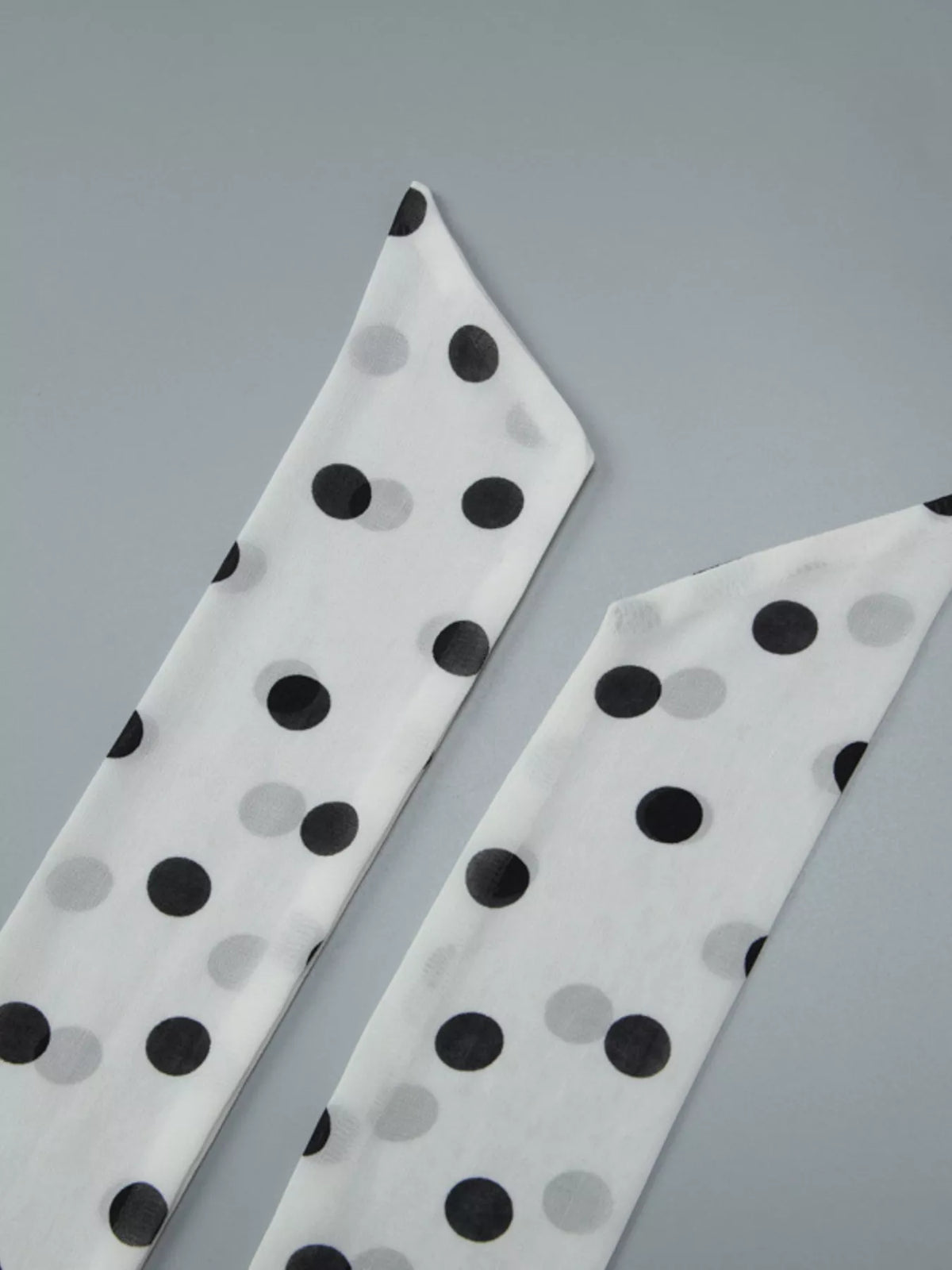 White polka dot halter dress laid flat