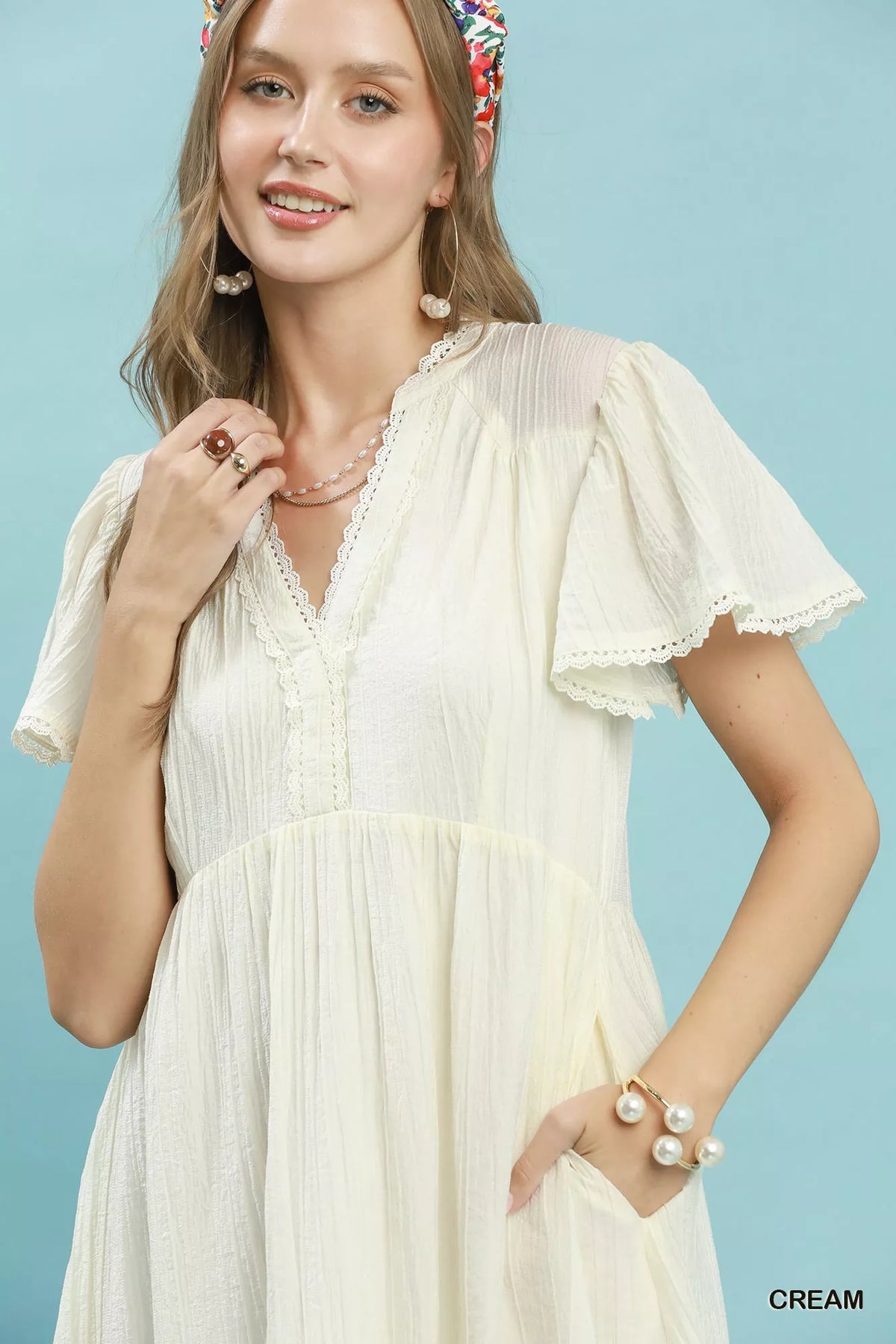 Cream textured lace trim tiered midi dress close up view