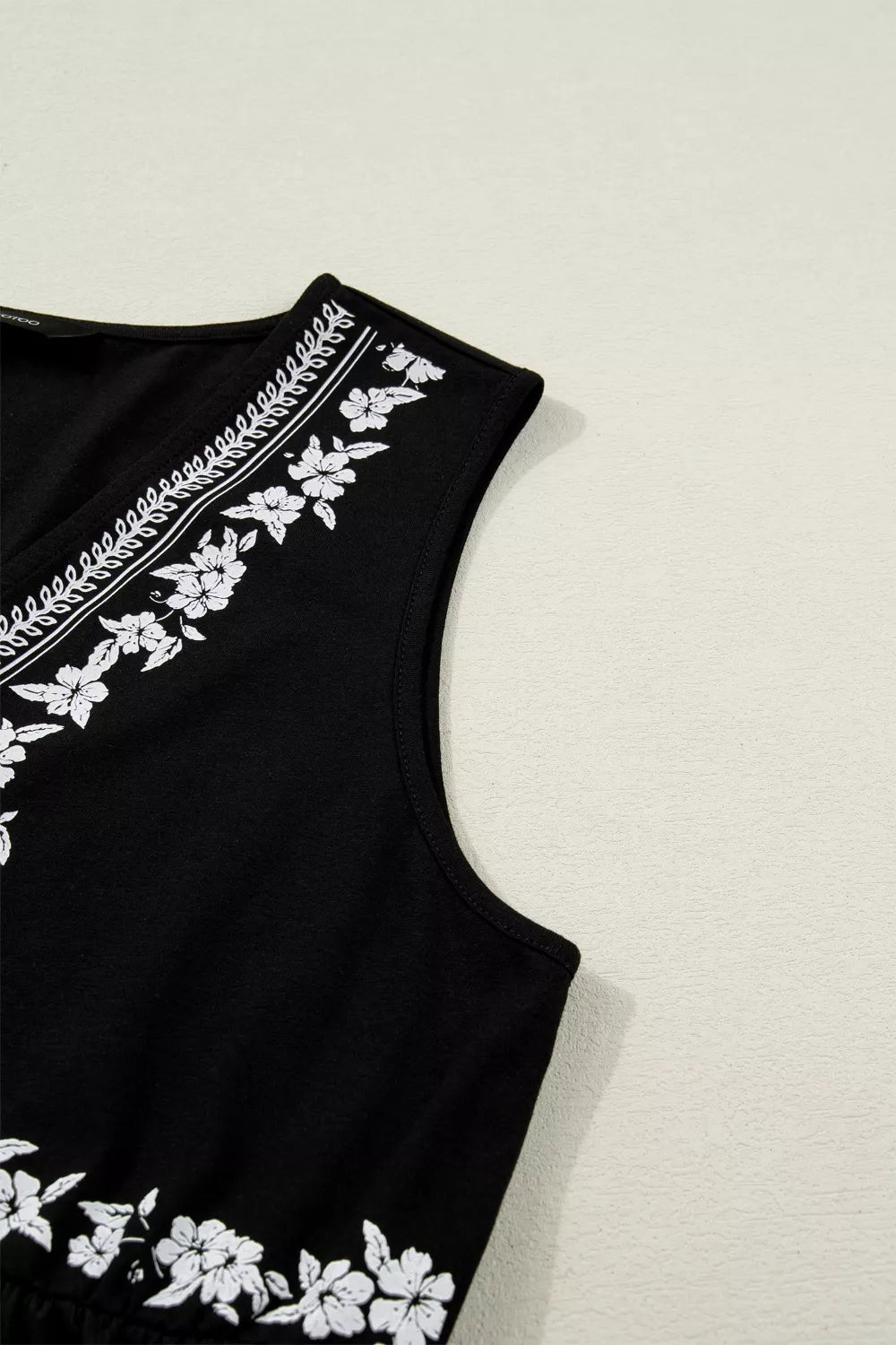 Floral embroidered top shown from a three quarter angle
