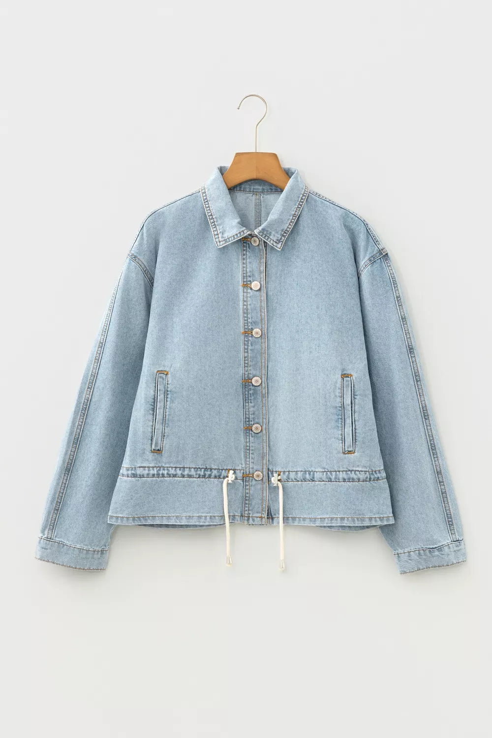 Front view of the buttoned denim jacket in light blue