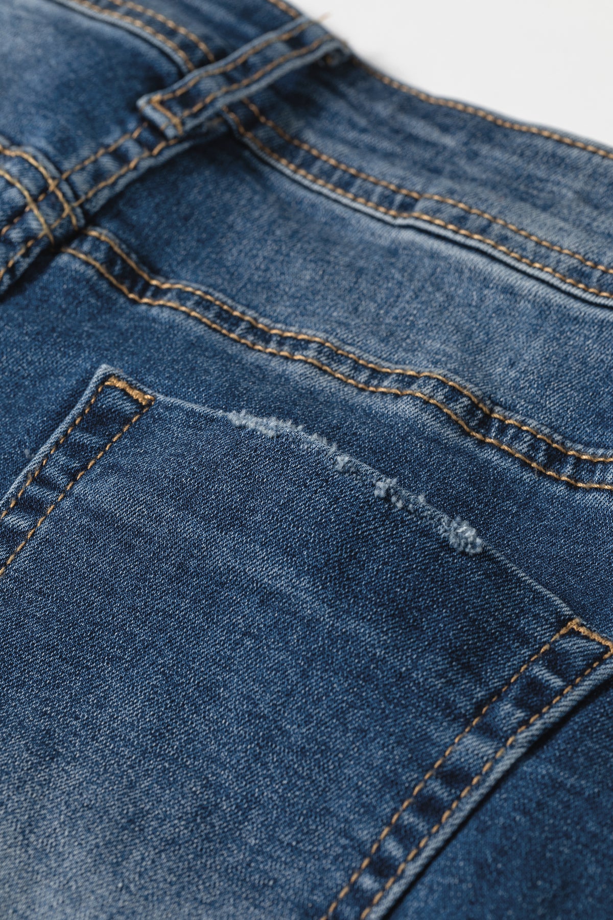 Acid wash jeans five pocket design detail