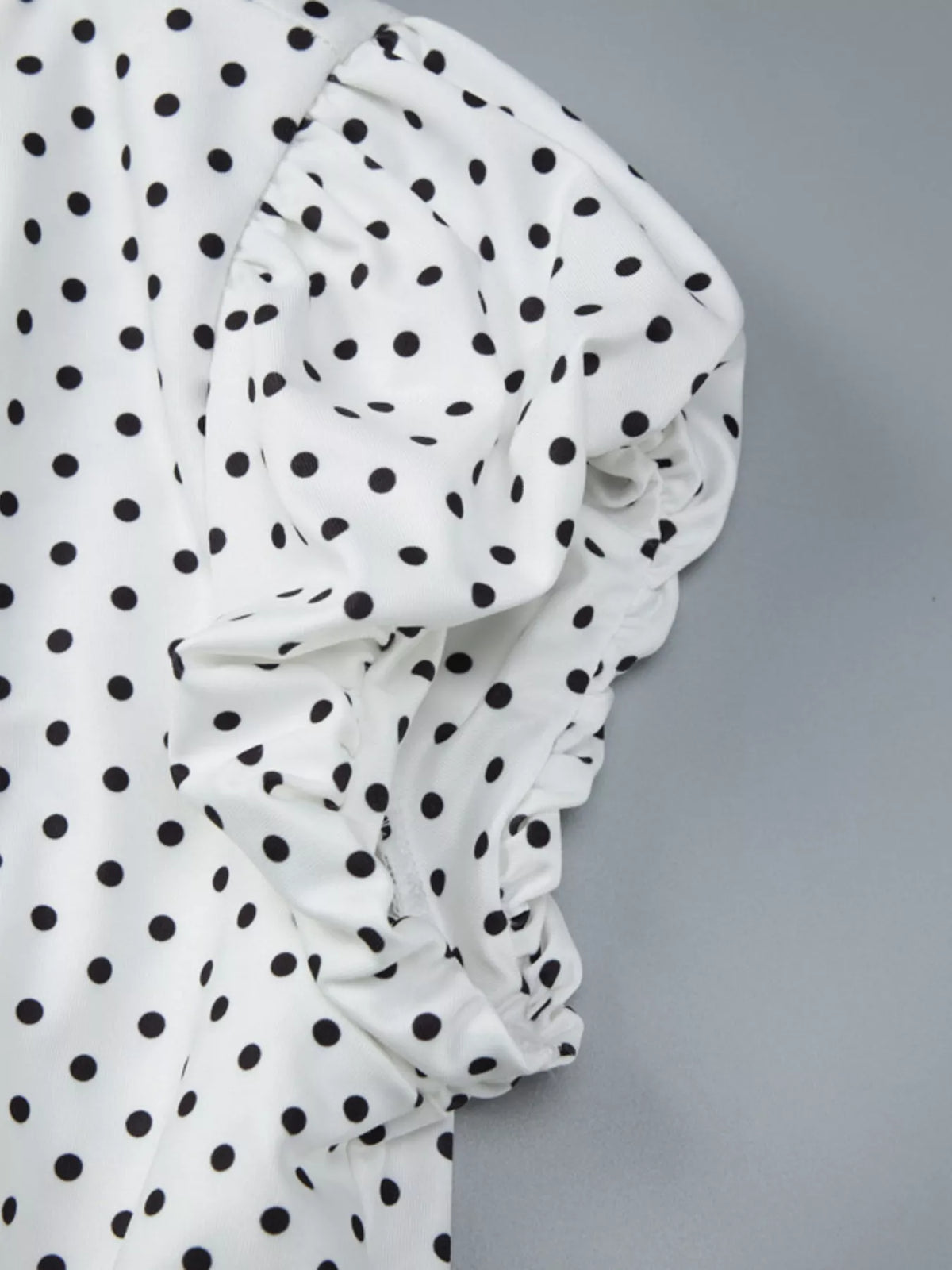 Ruched polka dot top styled with trousers