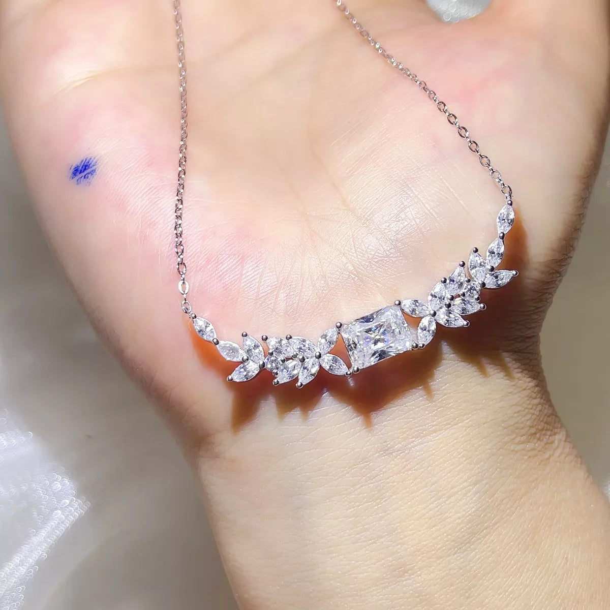 Moissanite pendant shown close to display the stone and setting