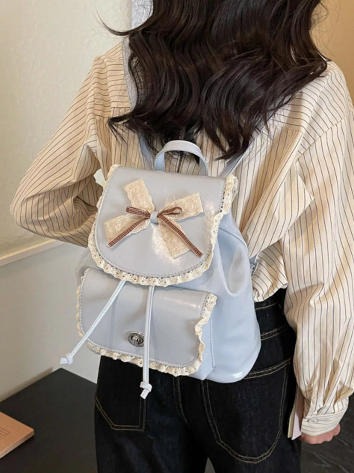 Blue lace bow mini backpack side profile