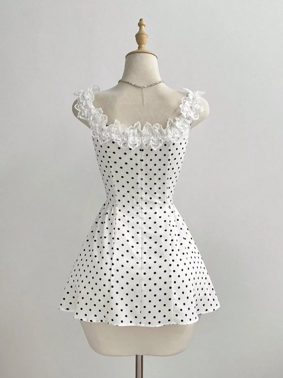 White polka dot dress neckline detail
