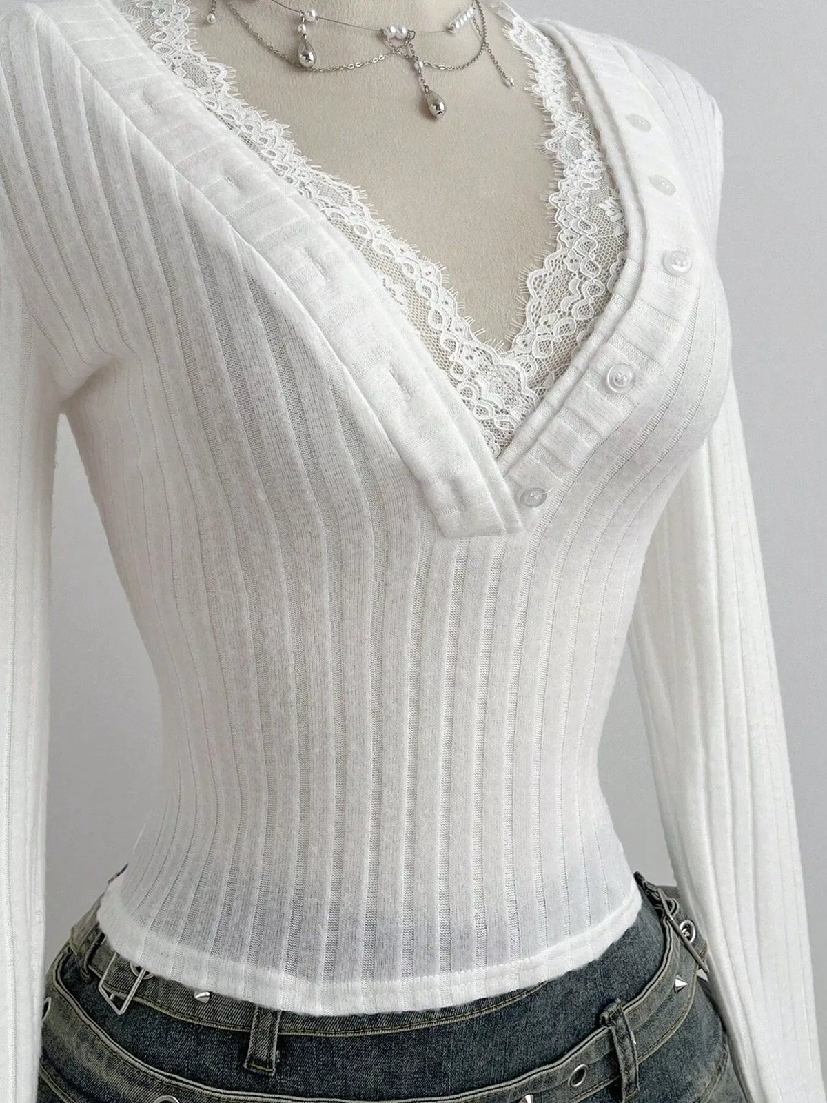 Lace trim detail along the V neckline of the knit top