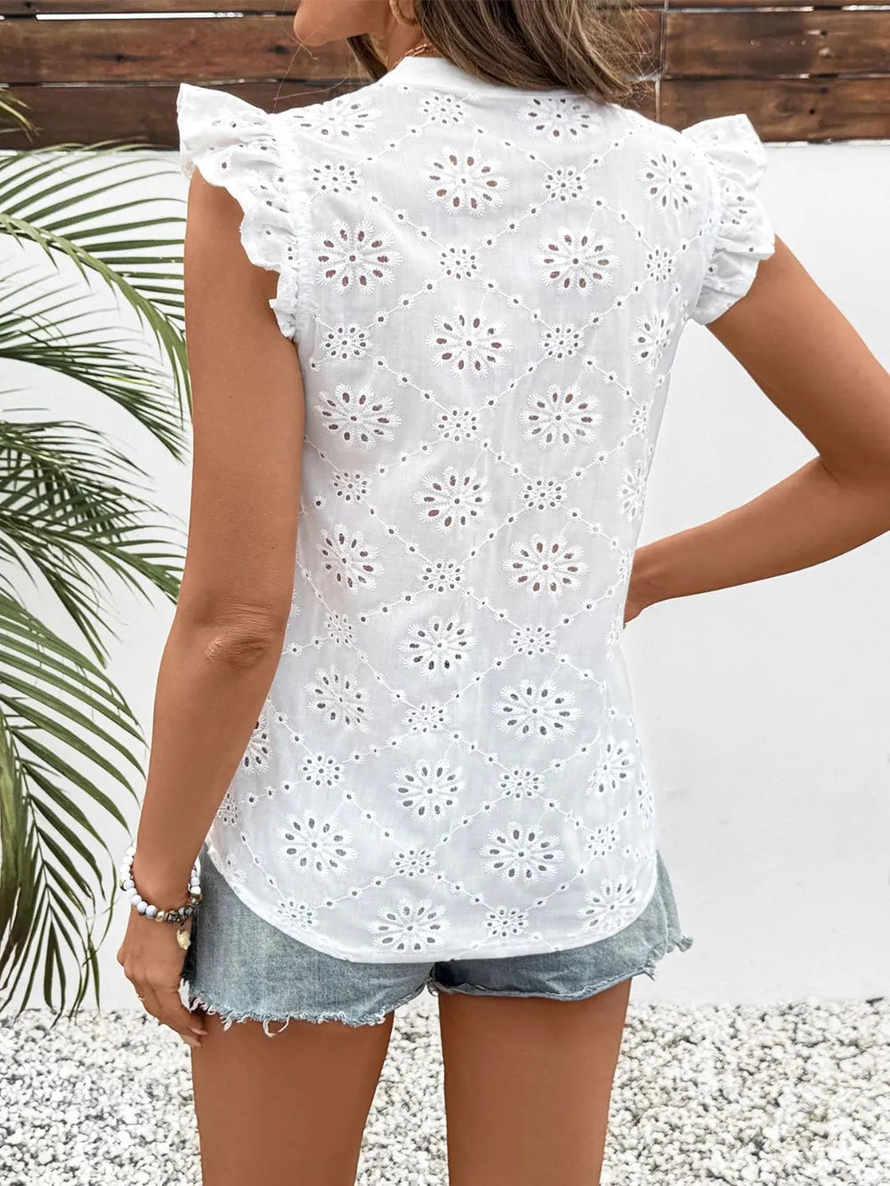 White eyelet blouse styled with shorts