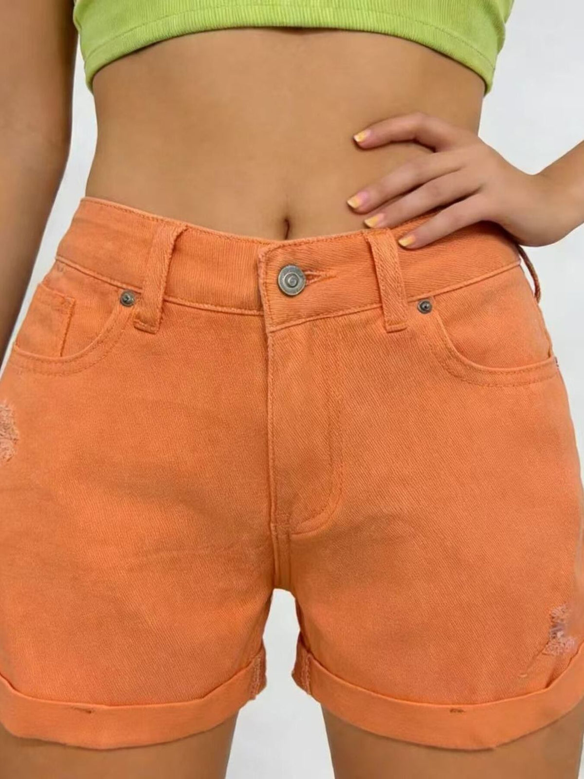 Ripped denim shorts three quarter view