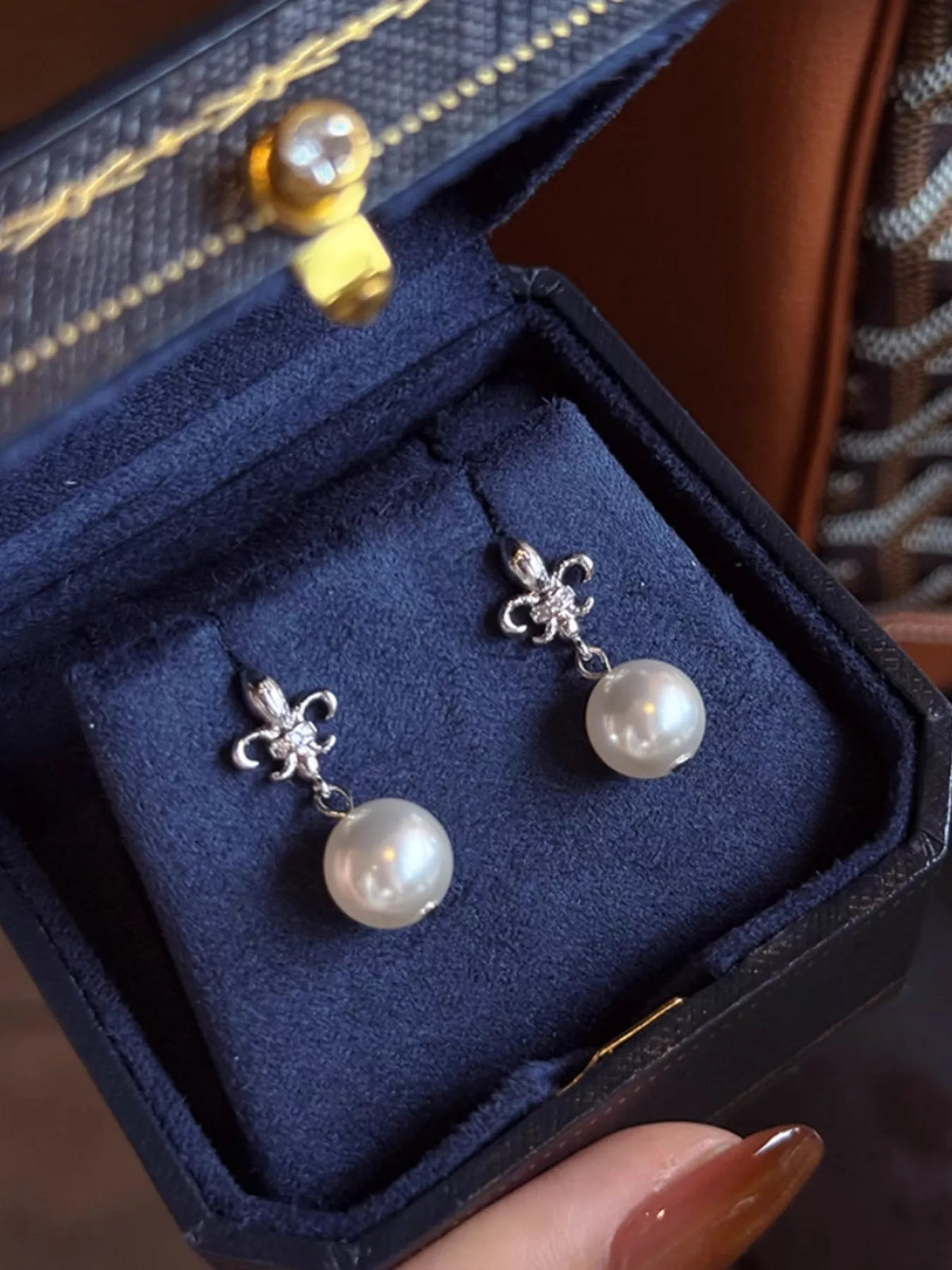 Pearl drop earrings close up detail