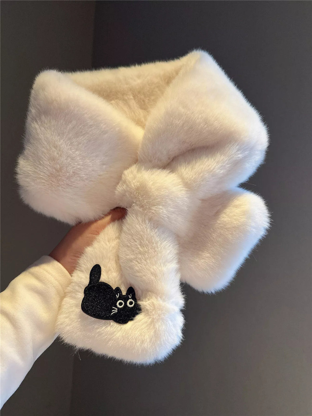 Close up of the cat embroidery on the plush scarf