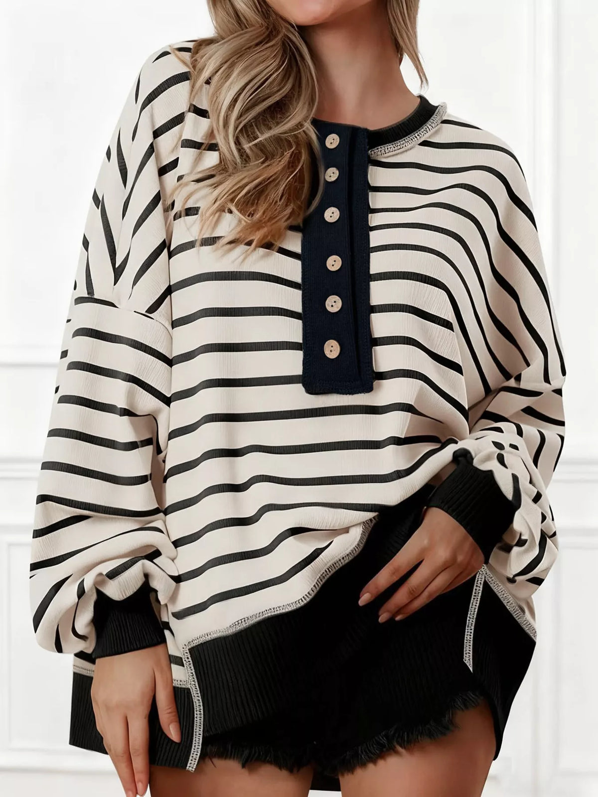 Exposed seam detail across the sweatshirt body