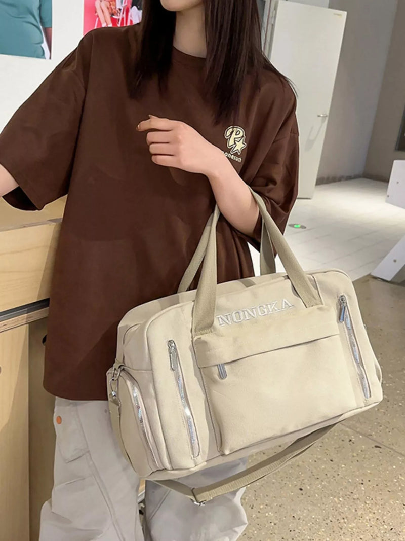 Beige canvas travel duffel with pockets front view