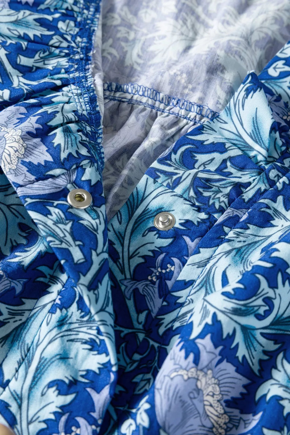 Dusty blue floral V neck tiered maxi dress back view