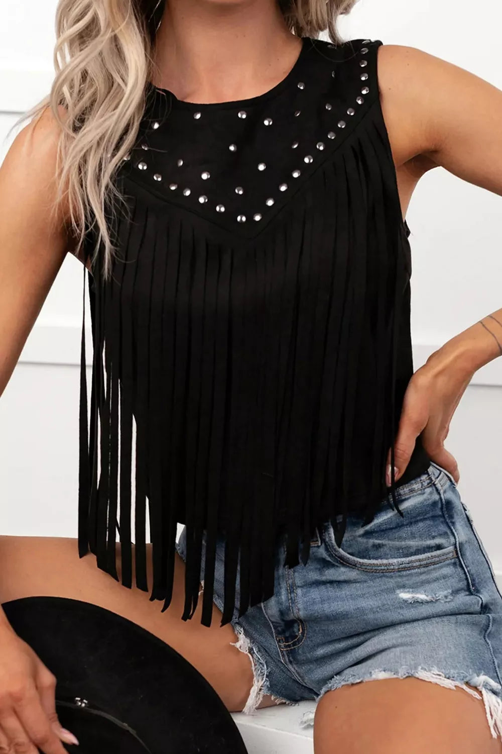 Black sleeveless top styled with denim