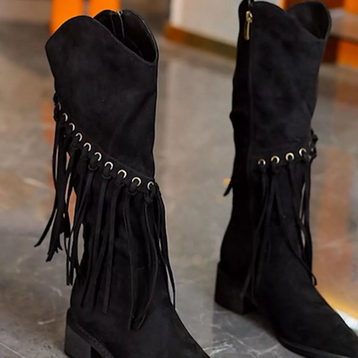 Fringed pointed toe block heel boots close up texture