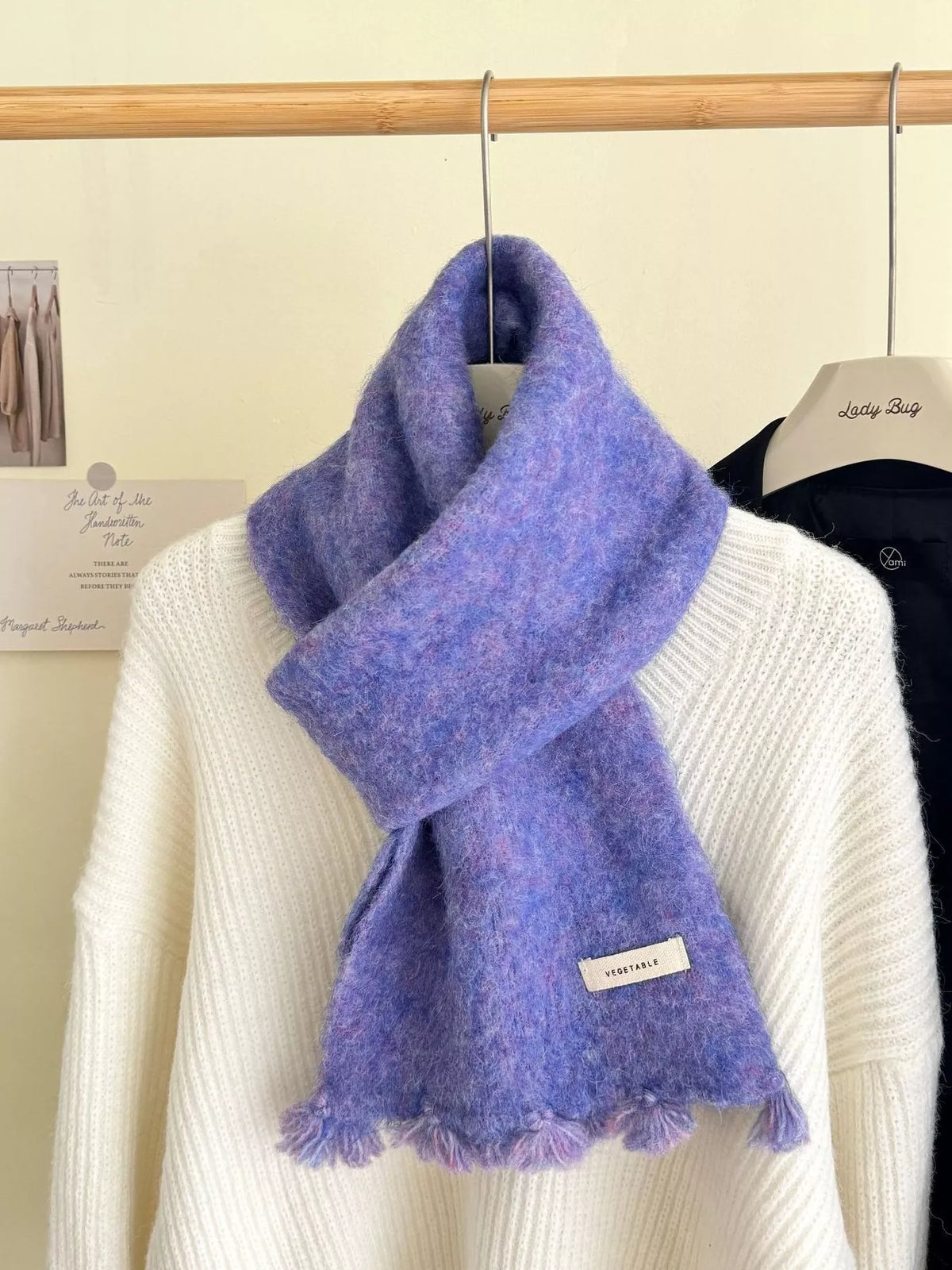 Wool knitted tassel scarf laid flat