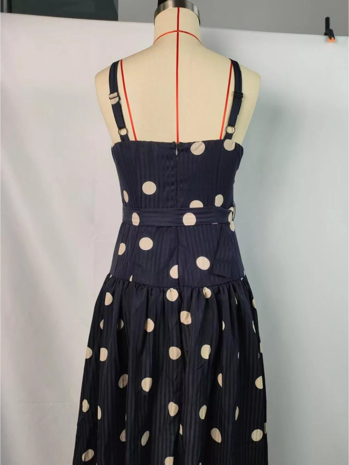 Black polka dot sweetheart neck midi dress detail view