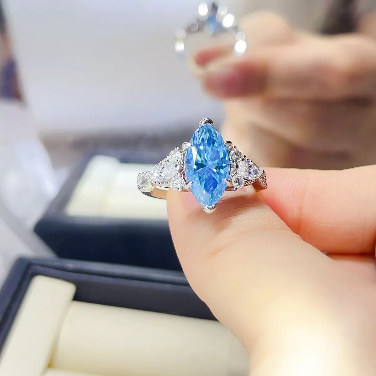 Close up of the pastel blue moissanite stone and silver setting