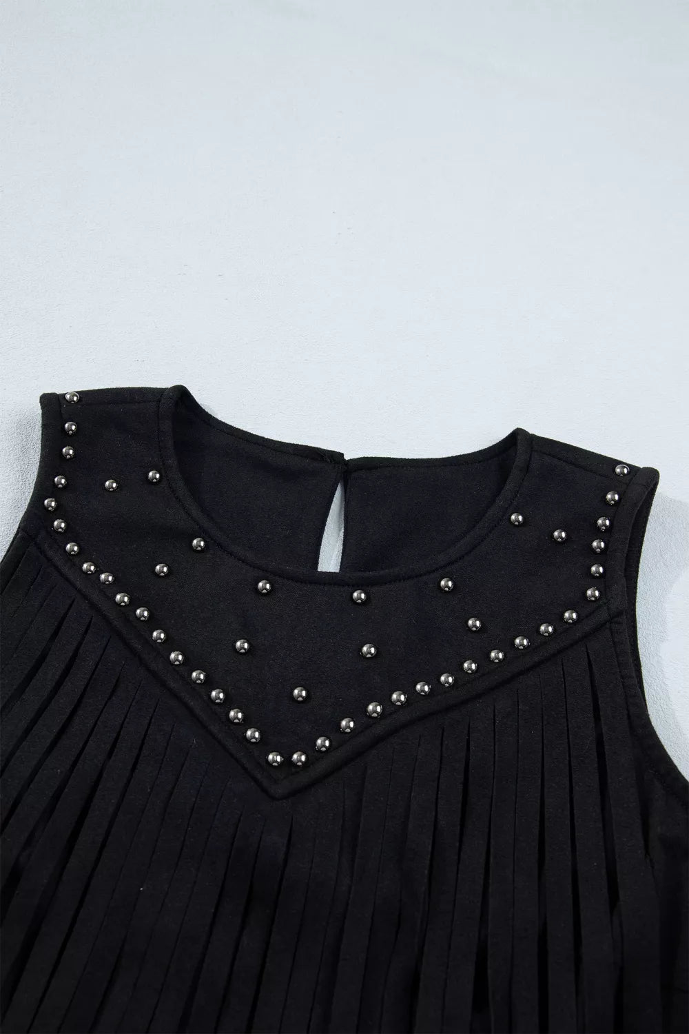 Sleeveless western top styled with boots