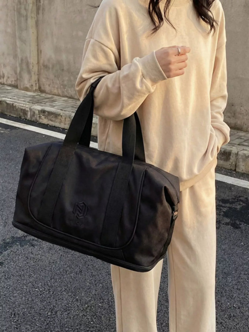 Black solid color nylon travel duffel bag front view