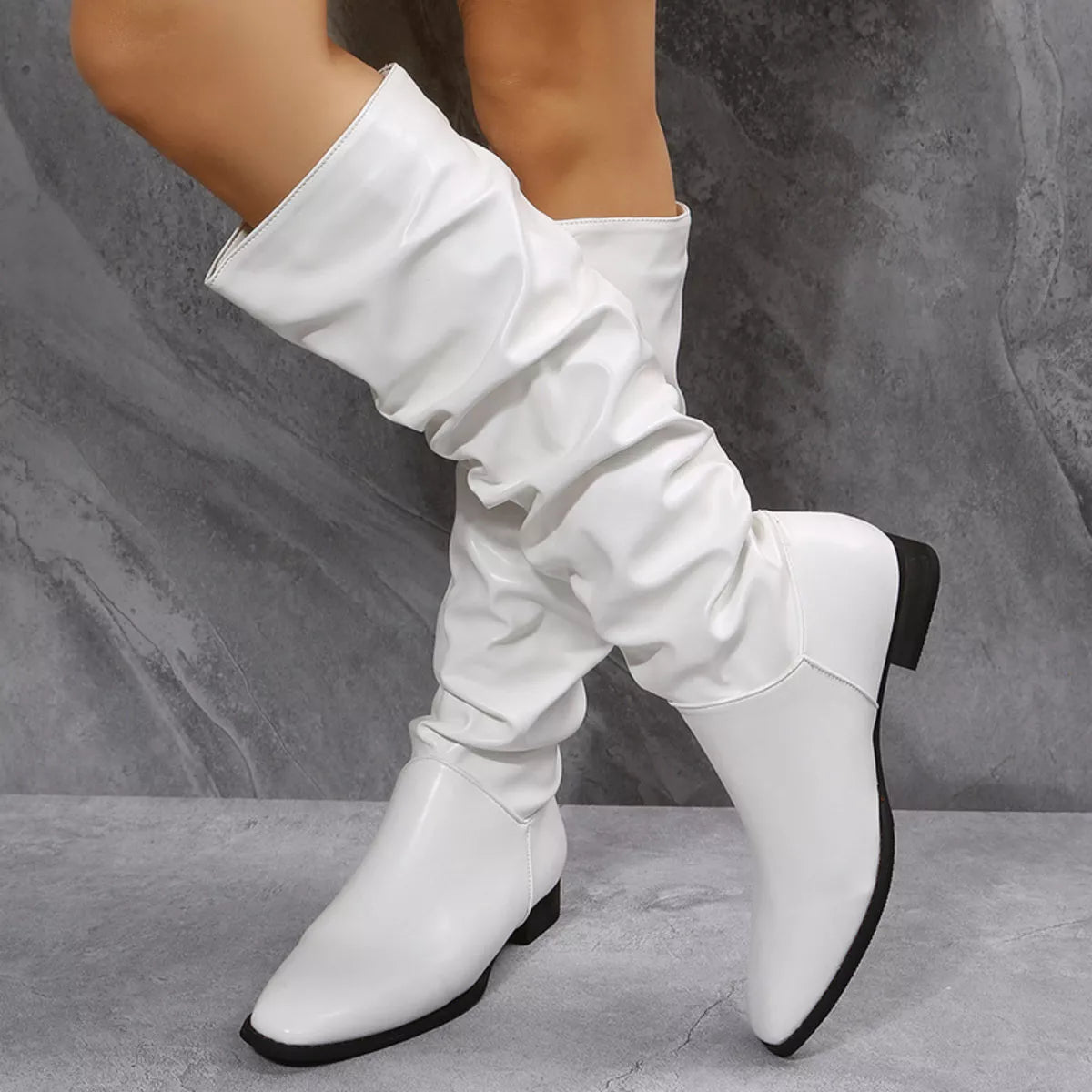 White slouchy block heel boots front view