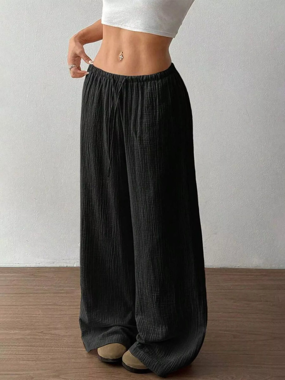 Drawstring pants shown from the back at an angle