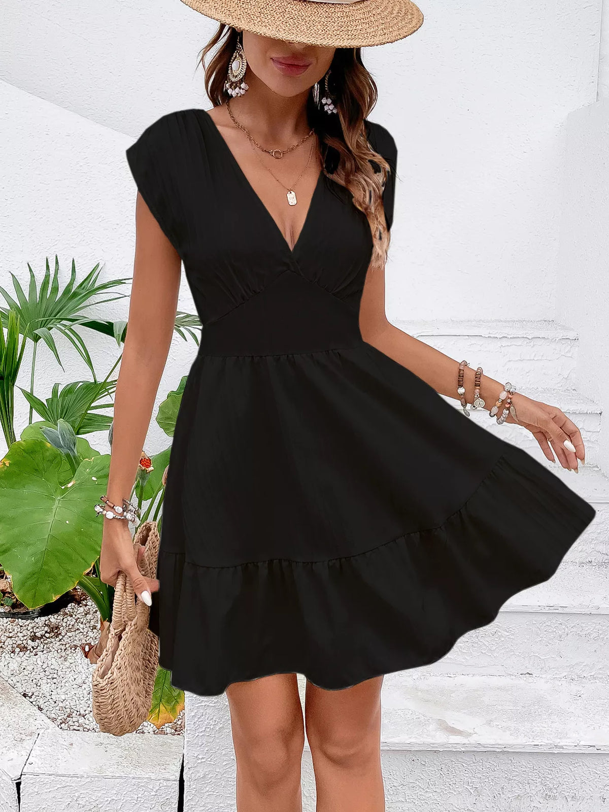 Three quarter view of tiered woven mini dress