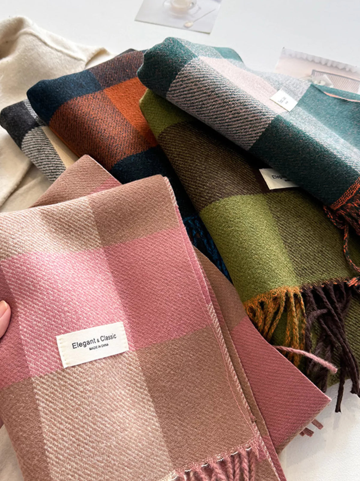 Pink plaid blanket scarf draped
