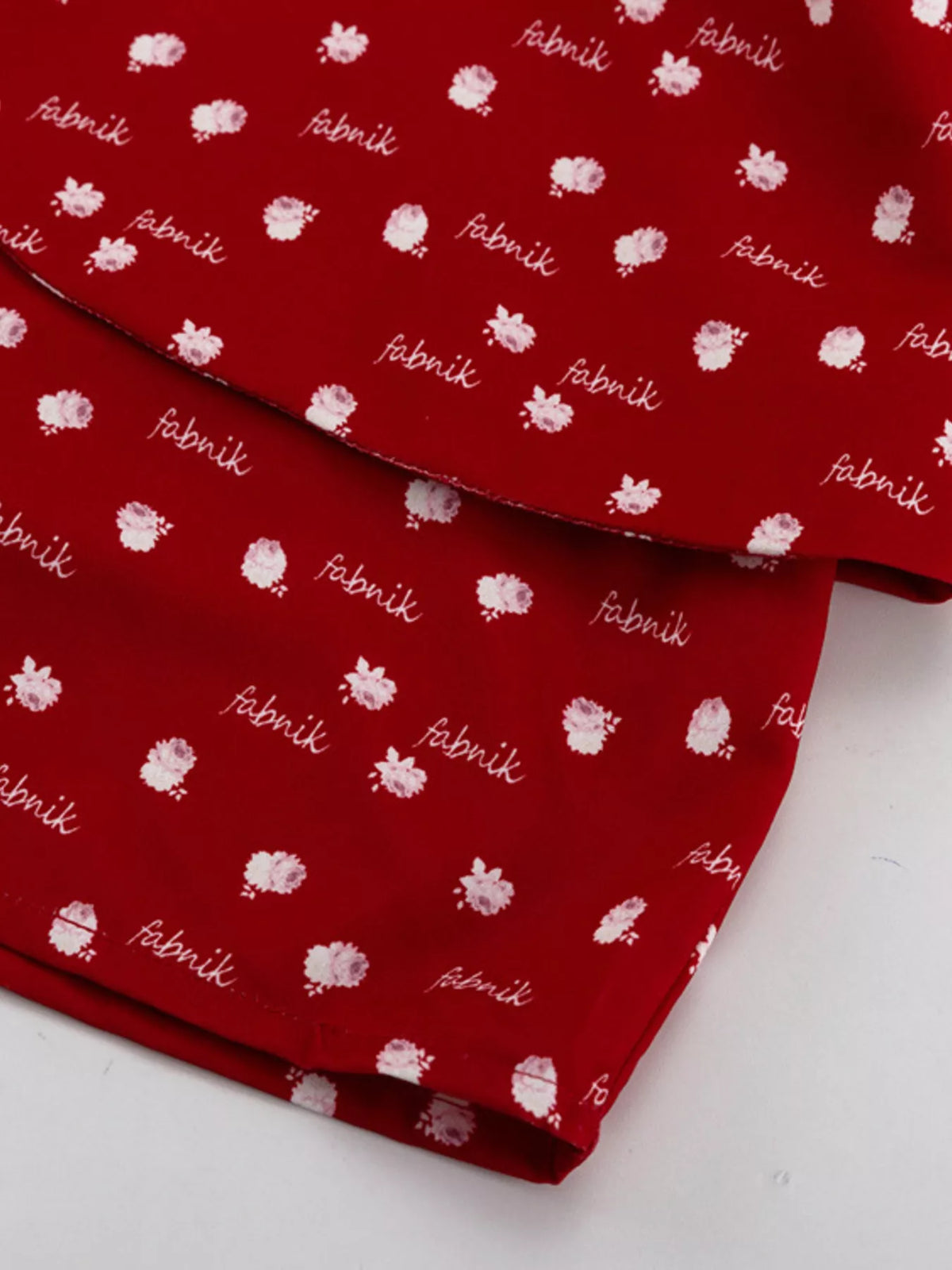 Scarlet polka dot dress hem and tier layers, close detail