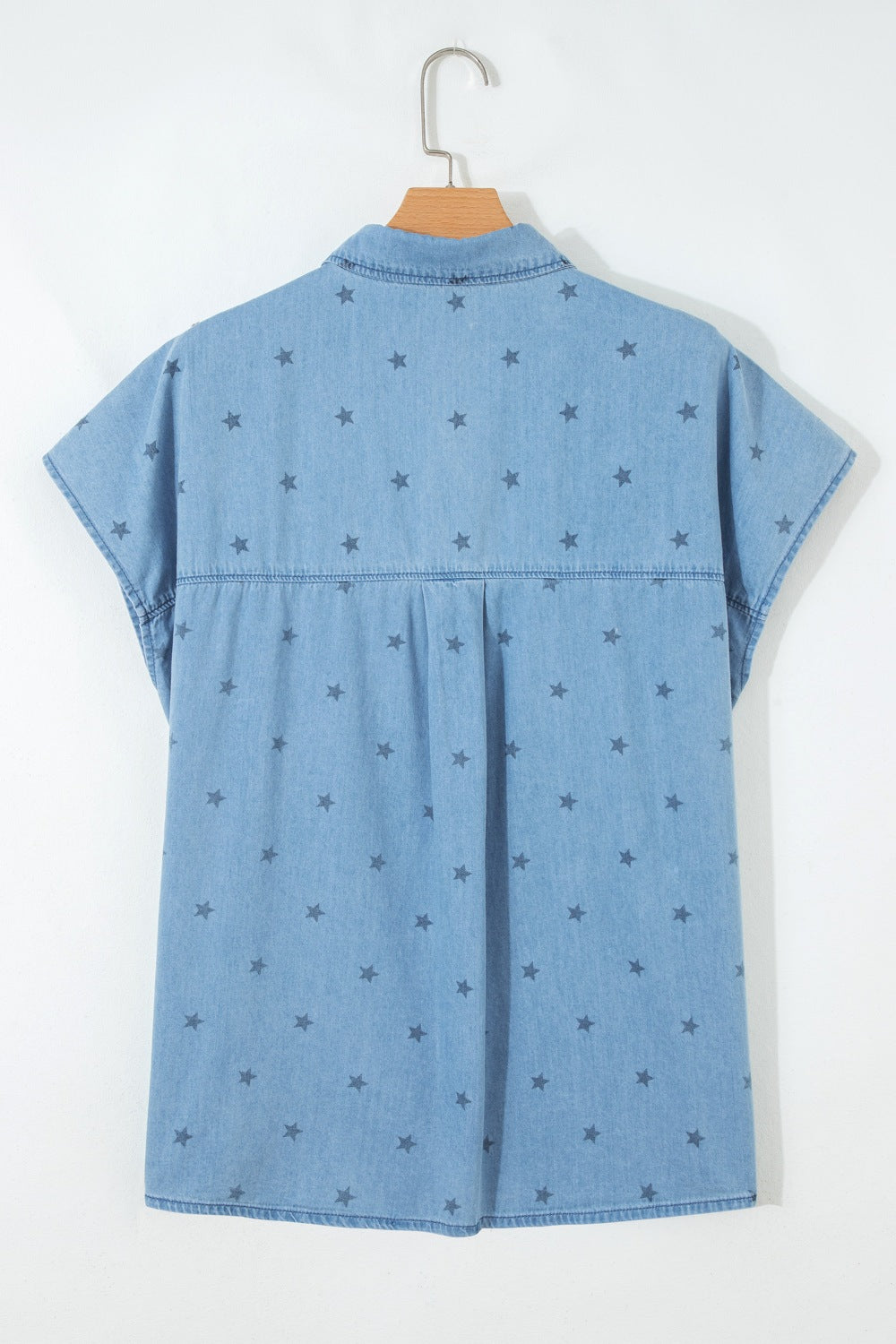 Light blue denim shirt worn open as a layer