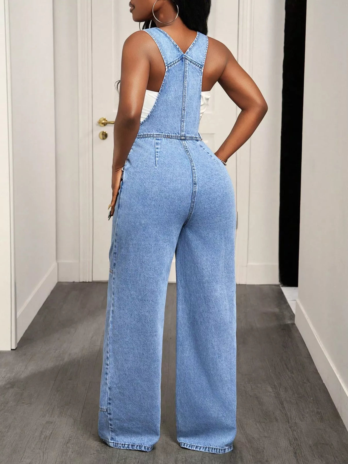 Wide leg hem detail on blue denim overalls
