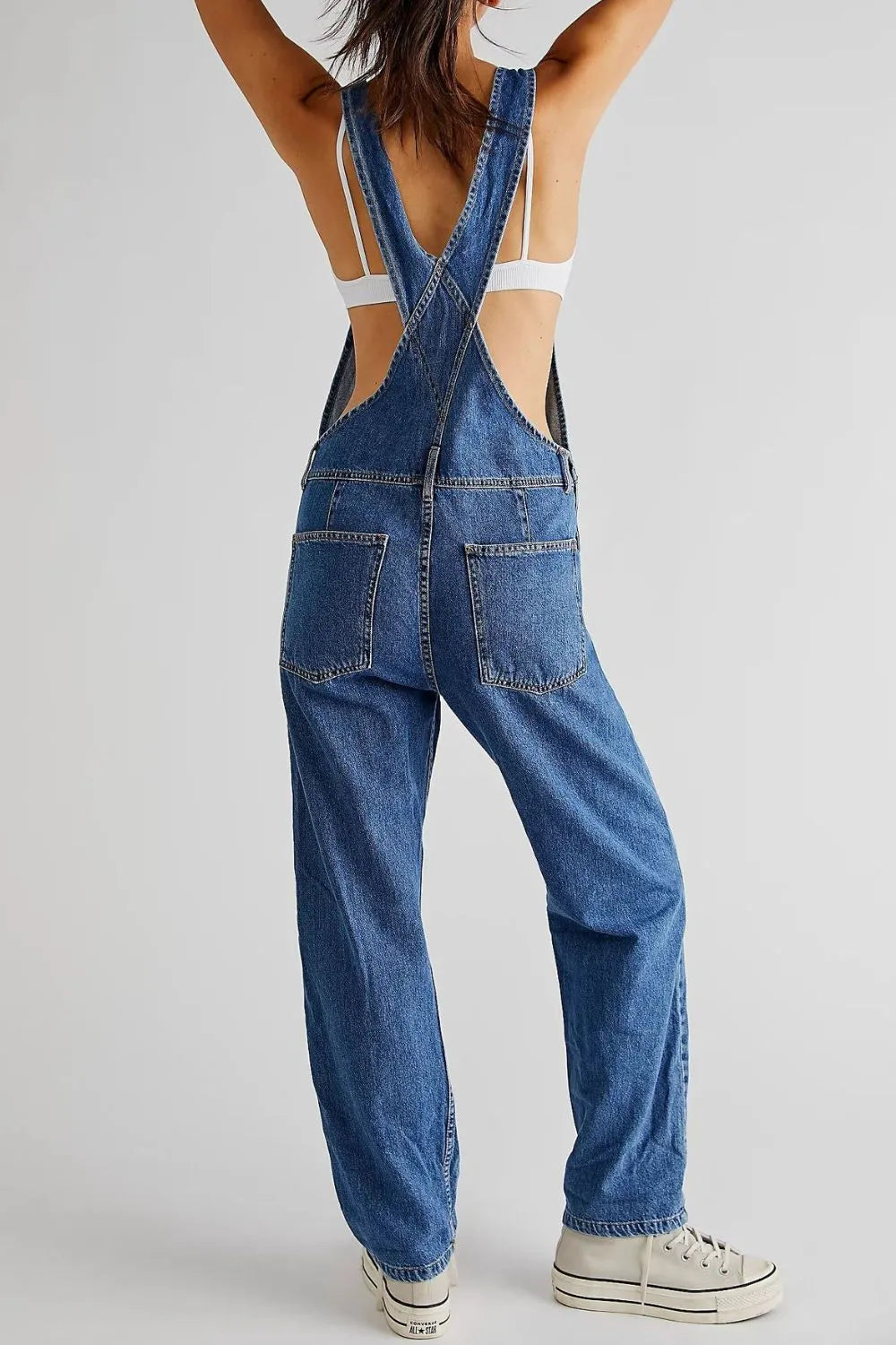 Medium wash long overalls side view