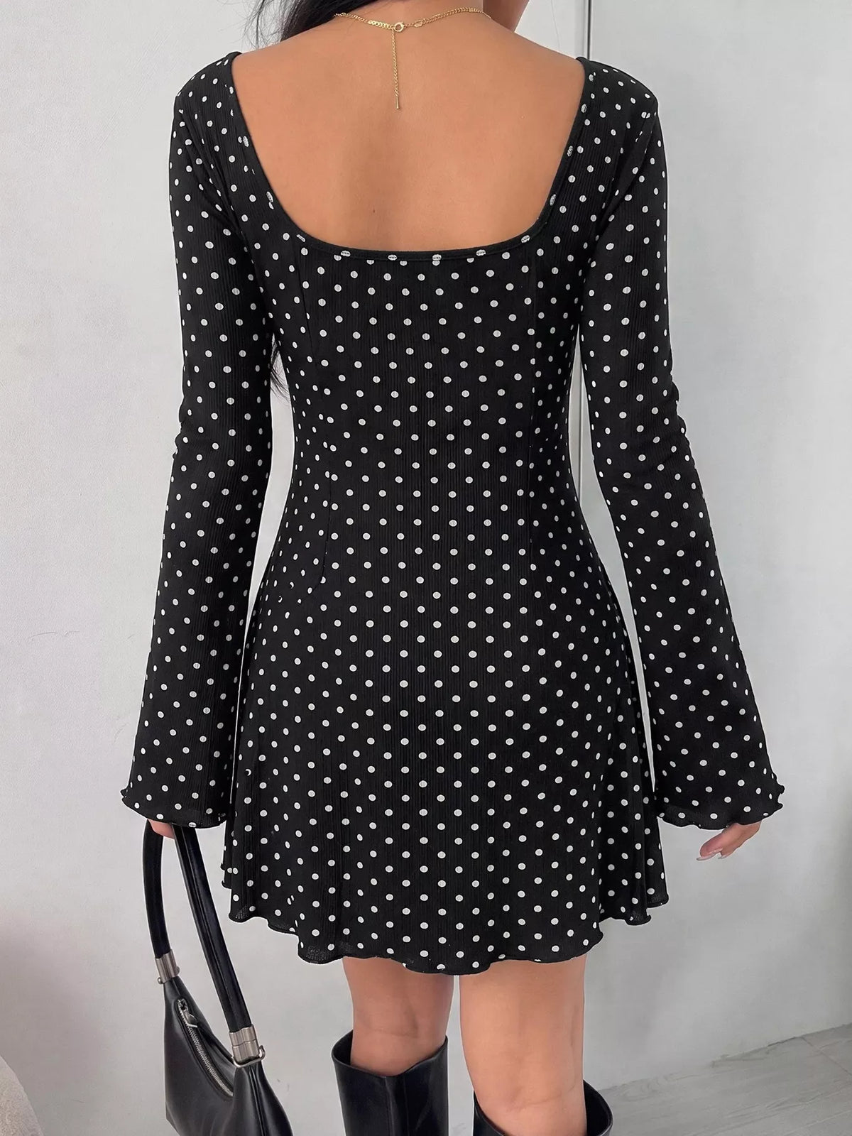 Side view of black polka dot mini dress