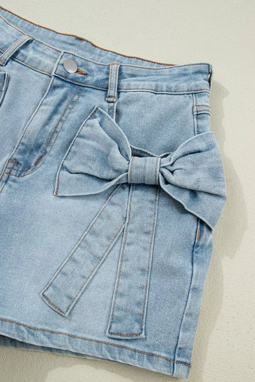 Light blue bow detail denim shorts side view