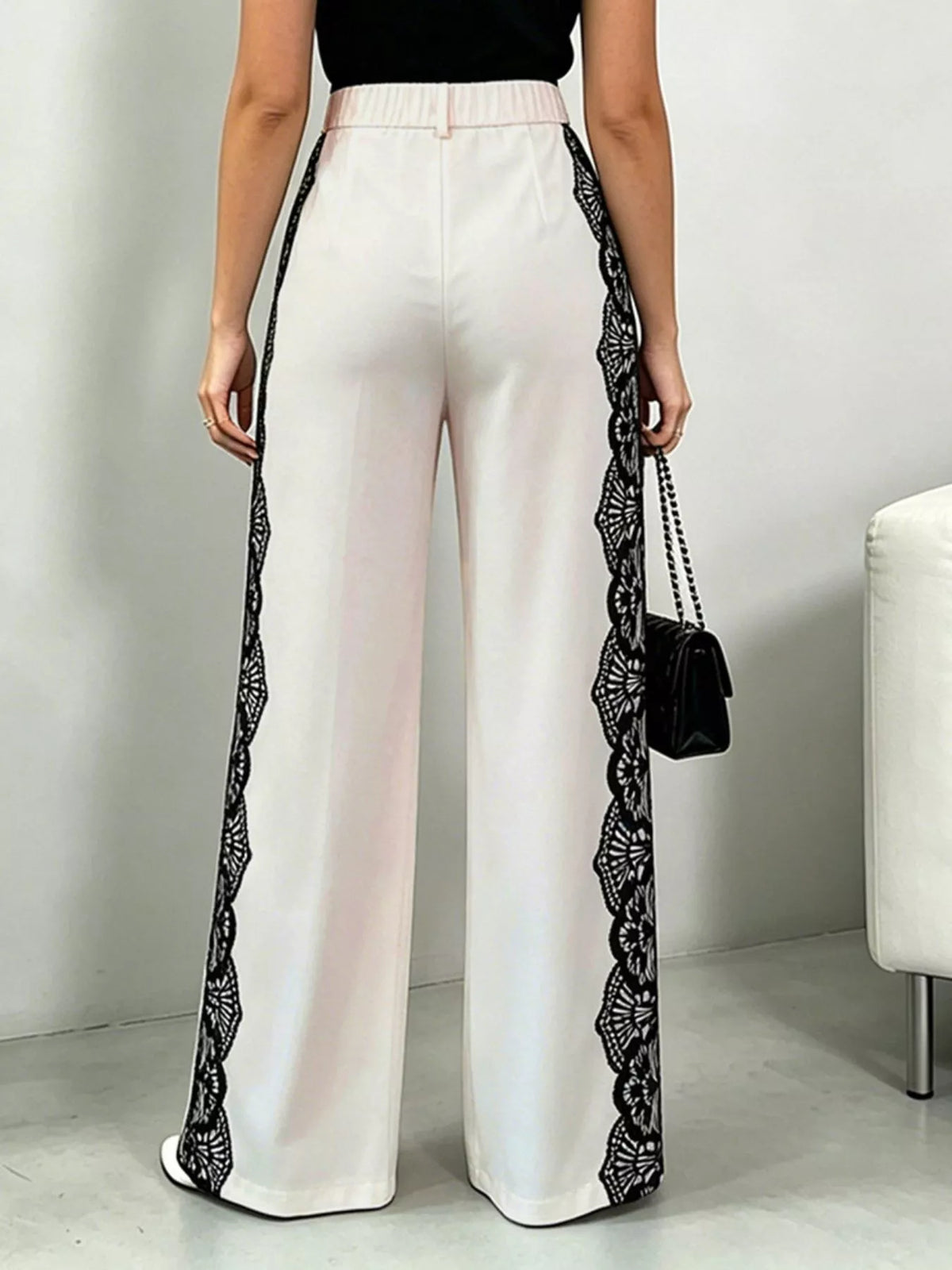 Beige wide leg pants lace detail closeup
