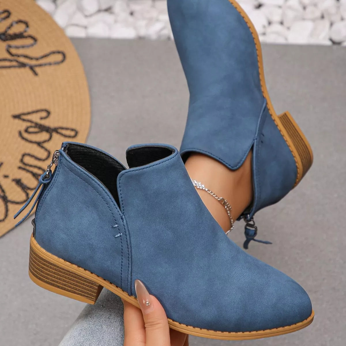 Point toe block heel ankle boots studio shot