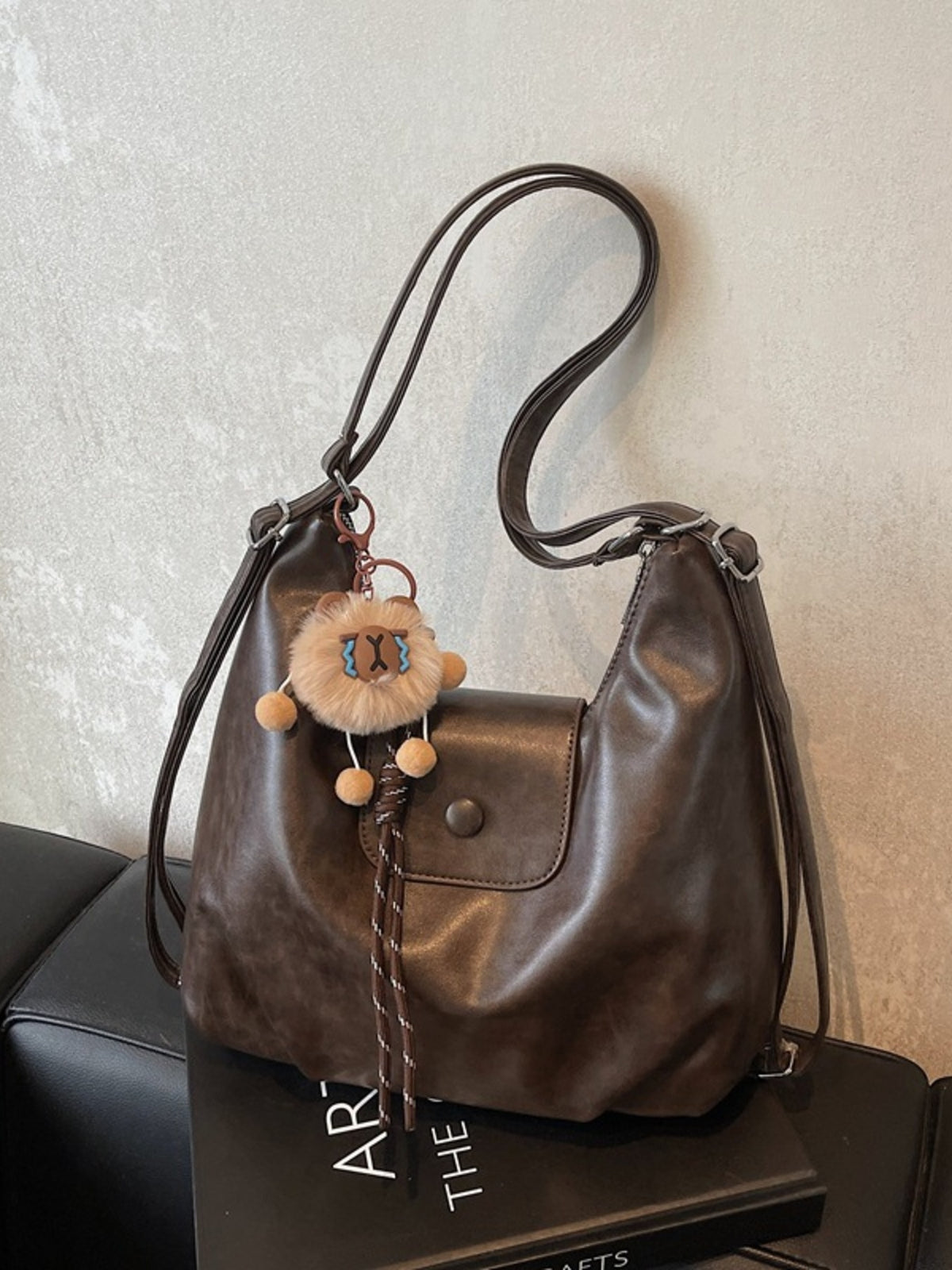 Adjustable strap shoulder bag shown from the side